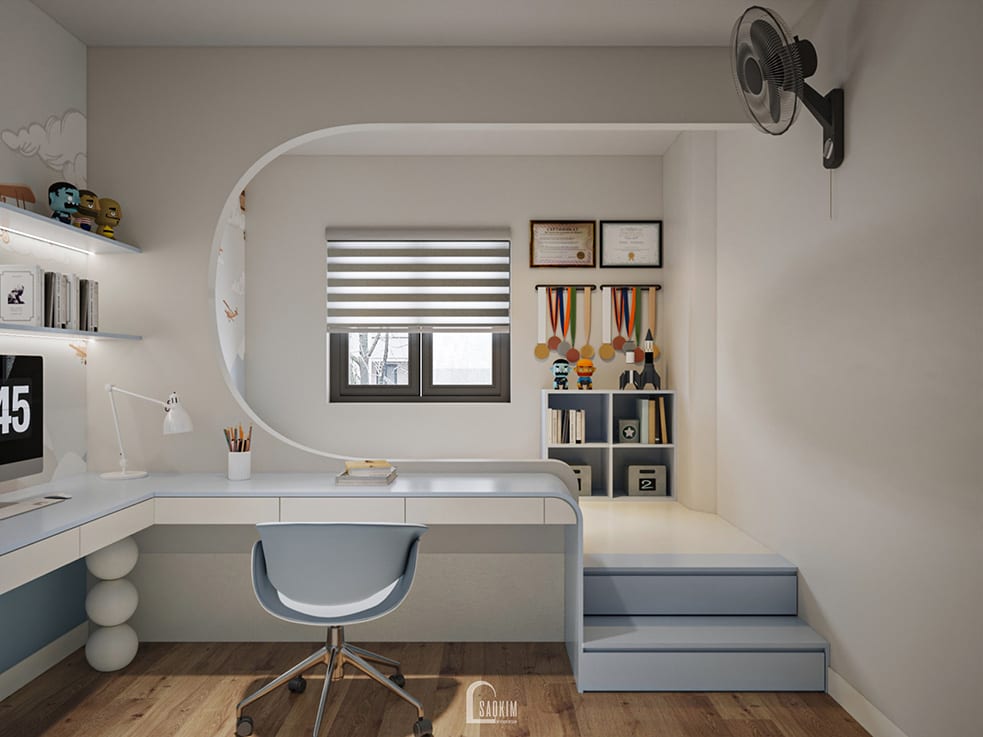 Thiết kế nội thất phòng bé trai nhà phố 5 tầng hiện đại – bàn học chữ L, kệ sách thông minh, gam màu xanh pastel nhẹ nhàng.